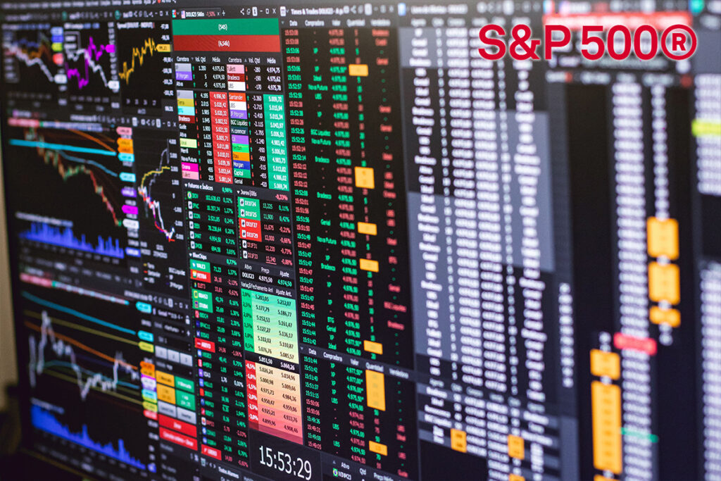 Wide view of multiple finance trading screens with colorful charts and a prominent S&P 500® logo in the upper-right corner.